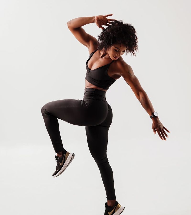 Woman in a dynamic cardio pose feeling energetic and vibrant.